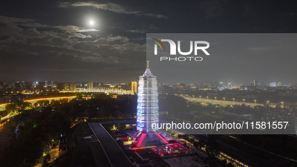 A supermoon appears over the Porcelain Tower of Nanjing in Nanjing, China, on September 17, 2024. 