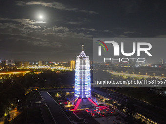 A supermoon appears over the Porcelain Tower of Nanjing in Nanjing, China, on September 17, 2024. (