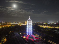 A supermoon appears over the Porcelain Tower of Nanjing in Nanjing, China, on September 17, 2024. (