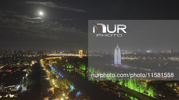 A supermoon appears over the Porcelain Tower of Nanjing in Nanjing, China, on September 17, 2024. 