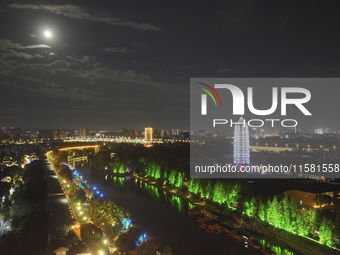 A supermoon appears over the Porcelain Tower of Nanjing in Nanjing, China, on September 17, 2024. (