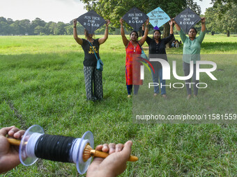 People fly kites with protest slogans written on them during a kite festival in Kolkata, India, on September 17, 2024. The rape and murder c...