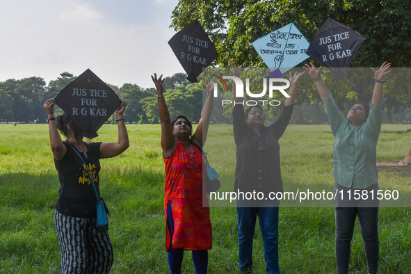 People fly kites with protest slogans written on them during a kite festival in Kolkata, India, on September 17, 2024. The rape and murder c...