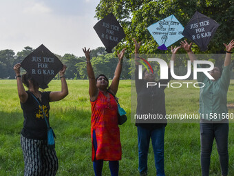 People fly kites with protest slogans written on them during a kite festival in Kolkata, India, on September 17, 2024. The rape and murder c...