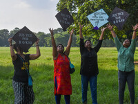 People fly kites with protest slogans written on them during a kite festival in Kolkata, India, on September 17, 2024. The rape and murder c...