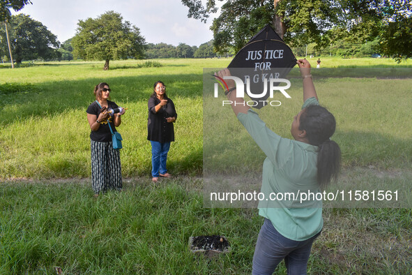 People fly kites with protest slogans written on them during a kite festival in Kolkata, India, on September 17, 2024. The rape and murder c...