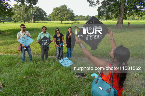 People fly kites with protest slogans written on them during a kite festival in Kolkata, India, on September 17, 2024. The rape and murder c...