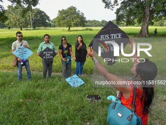 People fly kites with protest slogans written on them during a kite festival in Kolkata, India, on September 17, 2024. The rape and murder c...