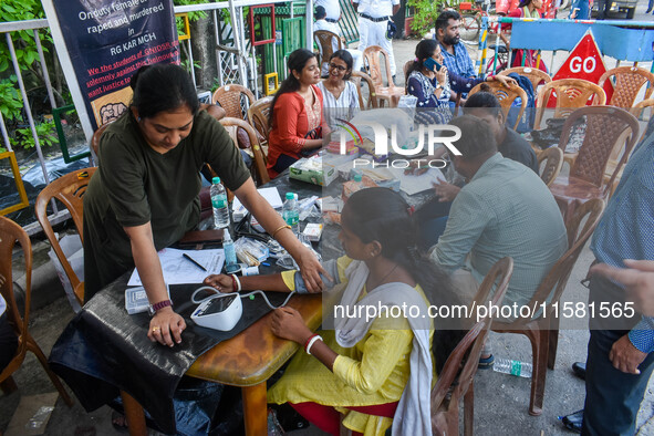 A doctor consults at a free clinic named ''Abhaya Clinic'' at the doctors' agitation site in front of the Health Ministry head office in Kol...