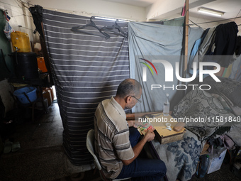 The Palestinian Yasser Abu Harbid, a 50-year-old displaced from northern Gaza to Deir al-Balah, lives in a school run by the United Nations...