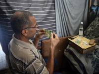 The Palestinian Yasser Abu Harbid, a 50-year-old displaced from northern Gaza to Deir al-Balah, lives in a school run by the United Nations...