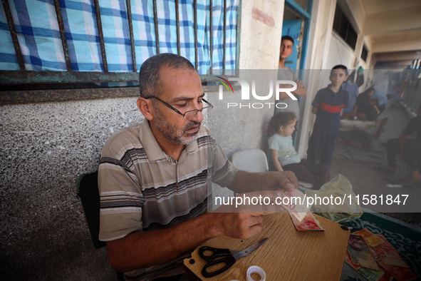 The Palestinian Yasser Abu Harbid, a 50-year-old displaced from northern Gaza to Deir al-Balah, lives in a school run by the United Nations...