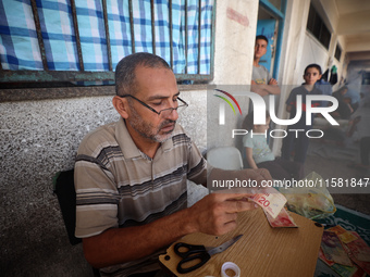 The Palestinian Yasser Abu Harbid, a 50-year-old displaced from northern Gaza to Deir al-Balah, lives in a school run by the United Nations...