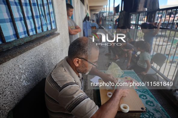 The Palestinian Yasser Abu Harbid, a 50-year-old displaced from northern Gaza to Deir al-Balah, lives in a school run by the United Nations...