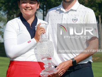 GAINESVILLE, VIRGINIA - SEPTEMBER 15: Allisen Corpuz of the United States poses with her caddie while holding the trophy after a Team USA wi...