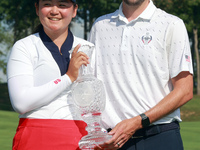 GAINESVILLE, VIRGINIA - SEPTEMBER 15: Allisen Corpuz of the United States poses with her caddie while holding the trophy after a Team USA wi...