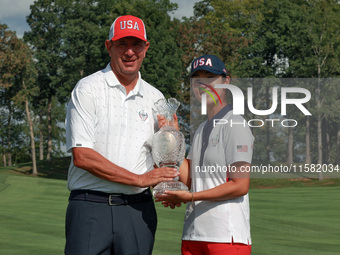 GAINESVILLE, VIRGINIA - SEPTEMBER 15: Andrea Lee of the United States poses with her caddie Robert Arft while holding the trophy after a Tea...