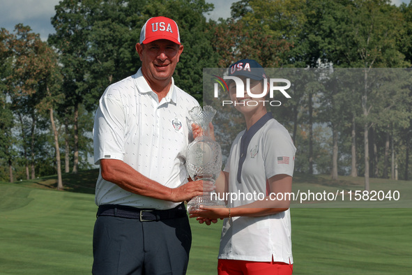 GAINESVILLE, VIRGINIA - SEPTEMBER 15: Andrea Lee of the United States poses with her caddie Robert Arft while holding the trophy after a Tea...