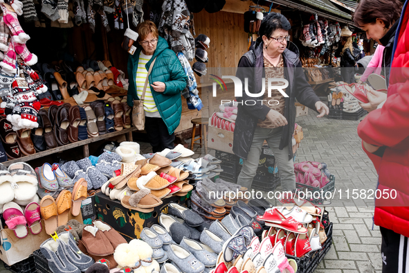 People buy winter sleepers on a landmark Krupowki Street in the center of Zakopane, a popular Tatra mountain holiday resort as Autumn cold w...