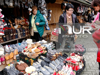 People buy winter sleepers on a landmark Krupowki Street in the center of Zakopane, a popular Tatra mountain holiday resort as Autumn cold w...