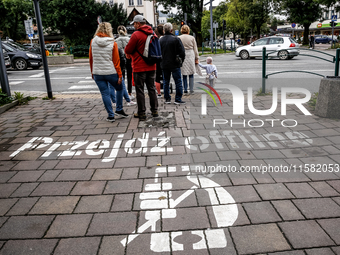 Walk offline sign is seen on a pavement on a landmark Krupowki Street in the center of Zakopane, a popular Tatra mountain holiday resort as...