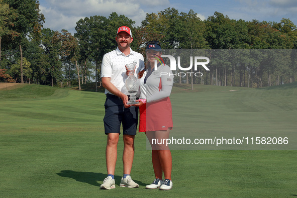 GAINESVILLE, VIRGINIA - SEPTEMBER 15: Lilia Vu of Team USA poses with her caddie Cole Pensanti  while holding the trophy after a Team USA wi...