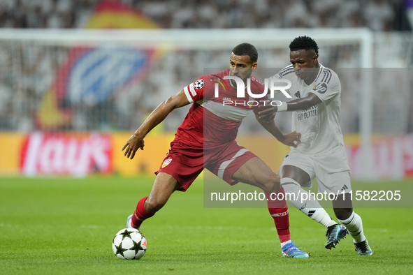 Josha Vagnoman right-back of Stuttgart and Germany and Vinicius Junior left winger of Real Madrid and Brazil compete for the ball during the...