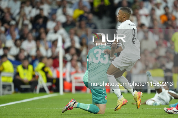 Kylian Mbappe centre-forward of Real Madrid and France and Alexander Nubel goalkeeper of Stuttgart and Germany compete for the ball during t...