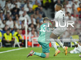 Kylian Mbappe centre-forward of Real Madrid and France and Alexander Nubel goalkeeper of Stuttgart and Germany compete for the ball during t...