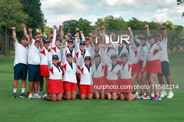 GAINESVILLE, VIRGINIA - SEPTEMBER 15: Team USA golfers pose with their caddies as a group on the 18th green at the conclusion of the Solheim...