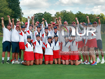 GAINESVILLE, VIRGINIA - SEPTEMBER 15: Team USA golfers pose with their caddies as a group on the 18th green at the conclusion of the Solheim...