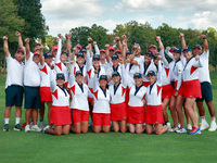 GAINESVILLE, VIRGINIA - SEPTEMBER 15: Team USA golfers pose with their caddies as a group on the 18th green at the conclusion of the Solheim...