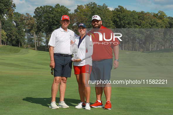 GAINESVILLE, VIRGINIA - SEPTEMBER 15: Lauren Coughlin of the United States poses with her significant other as well as her caddie while hold...