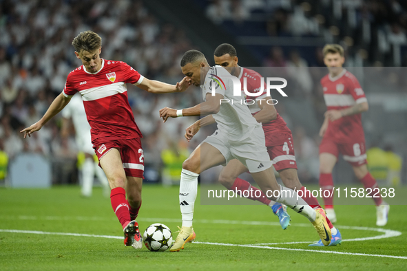 Kylian Mbappe centre-forward of Real Madrid and France and Anthony Rouault centre-back of Stuttgart and France compete for the ball during t...