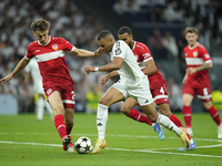 Kylian Mbappe centre-forward of Real Madrid and France and Anthony Rouault centre-back of Stuttgart and France compete for the ball during t...