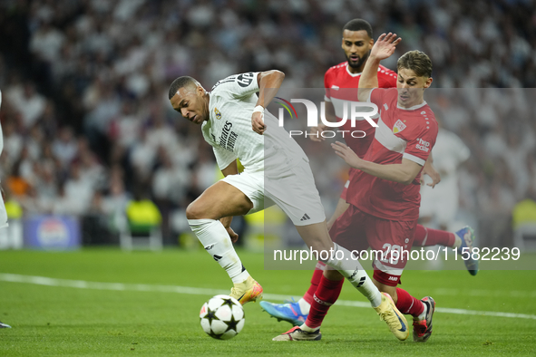 Kylian Mbappe centre-forward of Real Madrid and France and Anthony Rouault centre-back of Stuttgart and France compete for the ball during t...