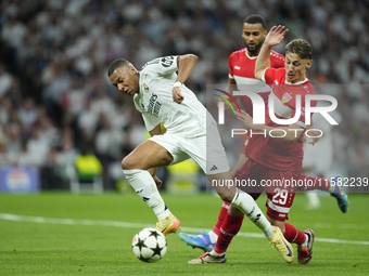 Kylian Mbappe centre-forward of Real Madrid and France and Anthony Rouault centre-back of Stuttgart and France compete for the ball during t...