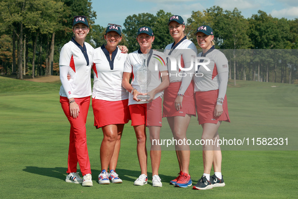 GAINESVILLE, VIRGINIA - SEPTEMBER 15: Team USA members pose as a group with the winners trophy, from left to right, Assistant Captain Paula...