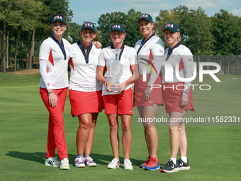 GAINESVILLE, VIRGINIA - SEPTEMBER 15: Team USA members pose as a group with the winners trophy, from left to right, Assistant Captain Paula...