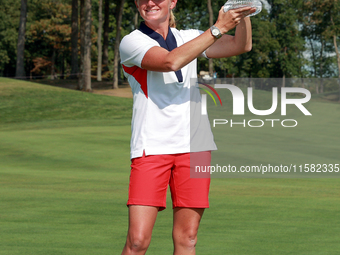 GAINESVILLE, VIRGINIA - SEPTEMBER 15: Team USA Captain Stacy Lewis raises the trophy at the conclusion of the Solheim Cup at Robert Trent Jo...