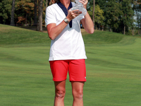 GAINESVILLE, VIRGINIA - SEPTEMBER 15: Team USA Captain Stacy Lewis kisses the trophy at the conclusion of the Solheim Cup at Robert Trent Jo...