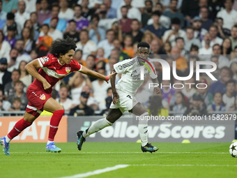 Vinicius Junior left winger of Real Madrid and Brazil and Anrie Chase centre-back of Stuttgart and Japan compete for the ball during the UEF...