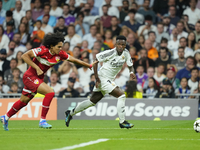 Vinicius Junior left winger of Real Madrid and Brazil and Anrie Chase centre-back of Stuttgart and Japan compete for the ball during the UEF...