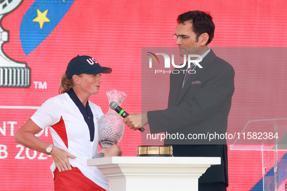 GAINESVILLE, VIRGINIA - SEPTEMBER 15: Captain Stacy Lewis of the United States speaks with sports commentator Grant Boone as she holds the t...