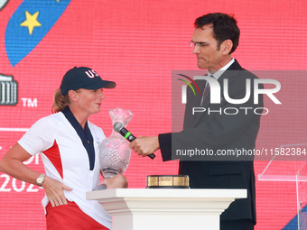 GAINESVILLE, VIRGINIA - SEPTEMBER 15: Captain Stacy Lewis of the United States speaks with sports commentator Grant Boone as she holds the t...