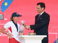 GAINESVILLE, VIRGINIA - SEPTEMBER 15: Captain Stacy Lewis of the United States speaks with sports commentator Grant Boone as she holds the t...