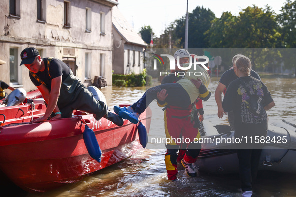 Residents are being evacuated by emergency workers after Nysa Klodzka river flooded town of Lewin Brzeski in southwestern Poland, on Septemb...