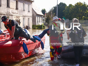 Residents are being evacuated by emergency workers after Nysa Klodzka river flooded town of Lewin Brzeski in southwestern Poland, on Septemb...