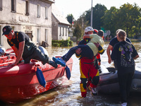 Residents are being evacuated by emergency workers after Nysa Klodzka river flooded town of Lewin Brzeski in southwestern Poland, on Septemb...