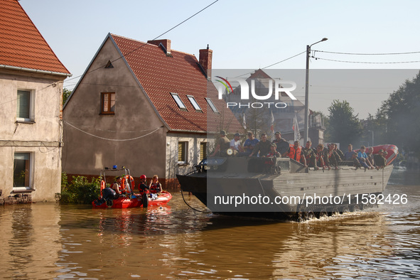 Residents are being evacuated by emergency workers on a military amphibious vehicle after Nysa Klodzka river flooded town of Lewin Brzeski i...